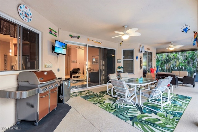 view of patio / terrace featuring a grill, a ceiling fan, and outdoor dining space