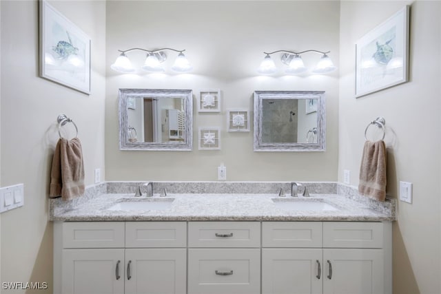 full bathroom featuring double vanity and a sink