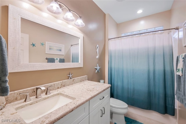 bathroom featuring shower / bath combo, vanity, and toilet