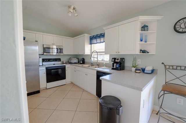 kitchen with white cabinetry, sink, stainless steel appliances, lofted ceiling, and light tile patterned floors