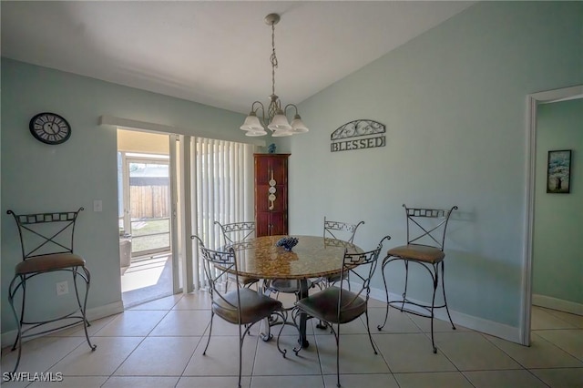 tiled dining space featuring lofted ceiling and a notable chandelier