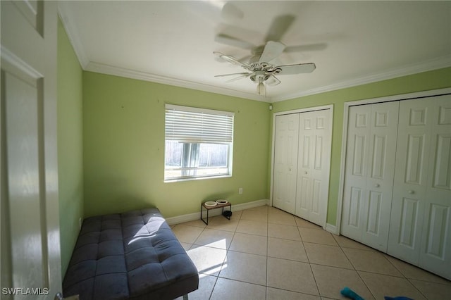 unfurnished room featuring ceiling fan, light tile patterned floors, and ornamental molding