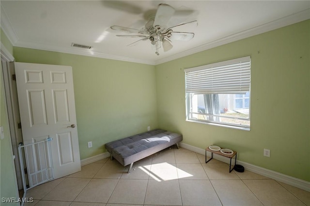 unfurnished bedroom with ceiling fan, light tile patterned flooring, and ornamental molding