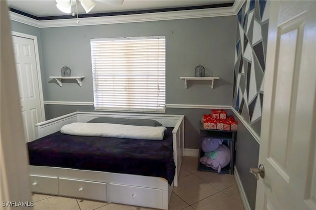 tiled bedroom with ceiling fan and ornamental molding