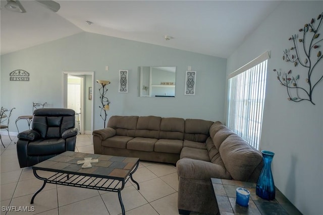 living room with ceiling fan, light tile patterned flooring, and vaulted ceiling