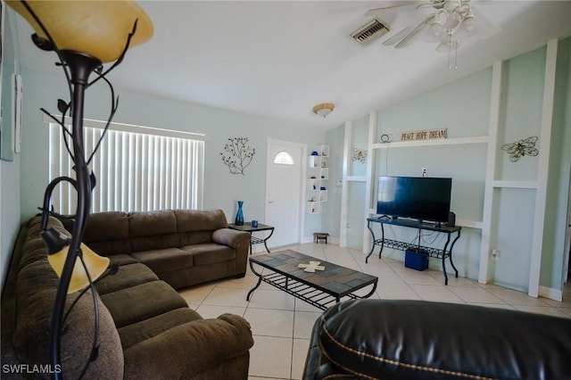 tiled living room with ceiling fan and lofted ceiling