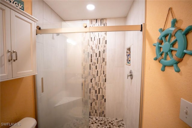 bathroom with toilet and walk in shower