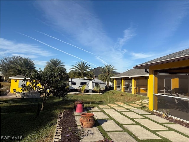 view of yard with a patio and a sunroom