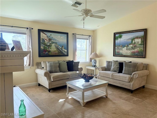 living room featuring ceiling fan and lofted ceiling