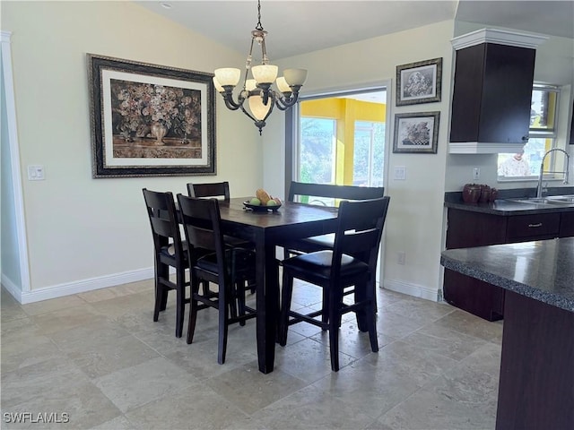 dining room featuring a chandelier, lofted ceiling, a healthy amount of sunlight, and sink