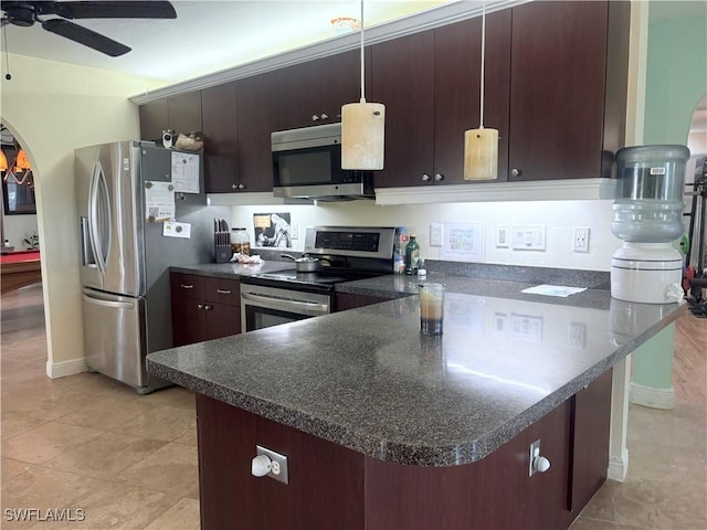 kitchen with kitchen peninsula, ceiling fan, appliances with stainless steel finishes, decorative light fixtures, and dark brown cabinetry