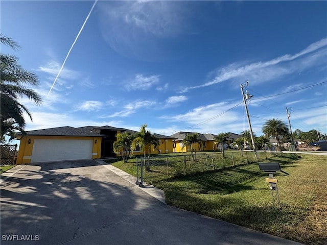 view of front of property featuring a garage and a front yard