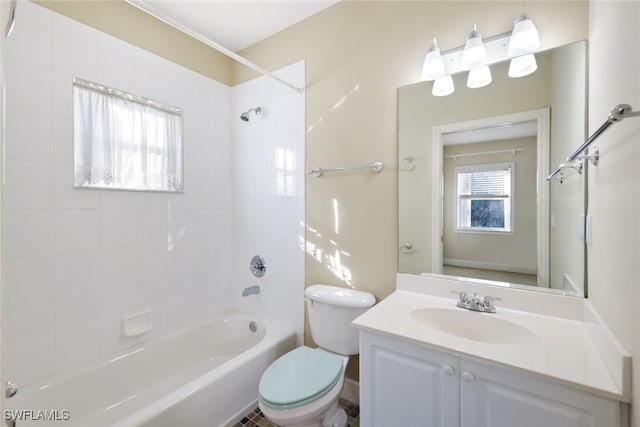 full bathroom with vanity, tiled shower / bath combo, and toilet