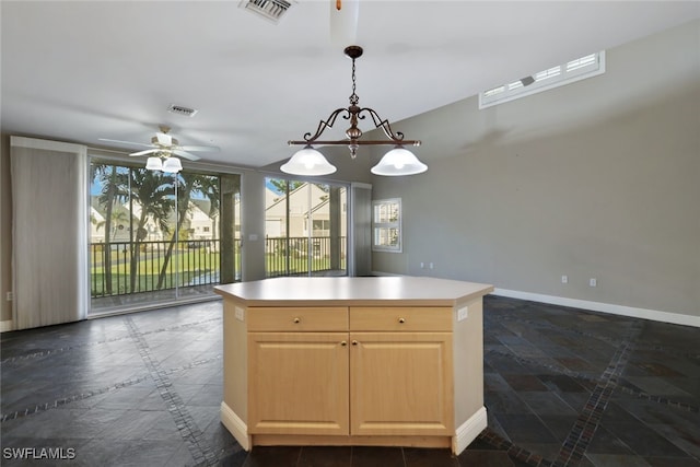 kitchen with light brown cabinets, decorative light fixtures, a kitchen island, and ceiling fan