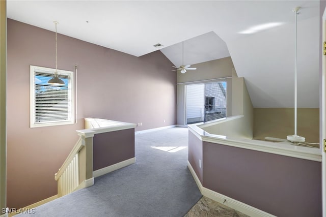 interior space with light colored carpet and vaulted ceiling