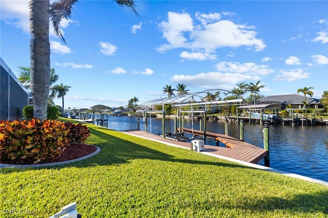 view of dock with a yard and a water view