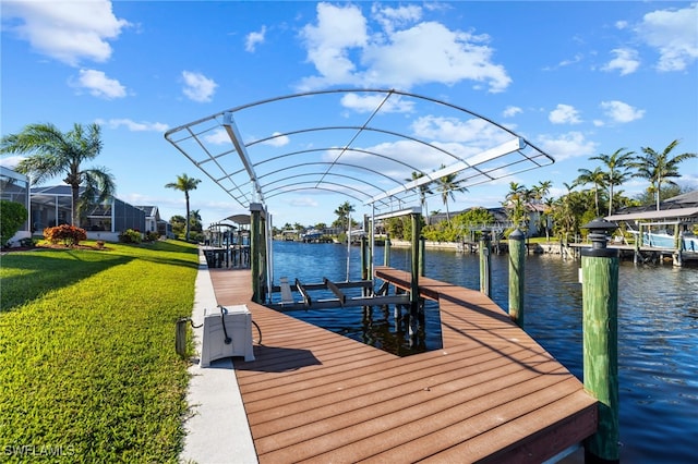 view of dock featuring a lawn and a water view