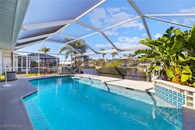 view of pool with a lanai, a water view, and a patio area