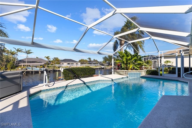 view of pool with a lanai, a patio, and a water view