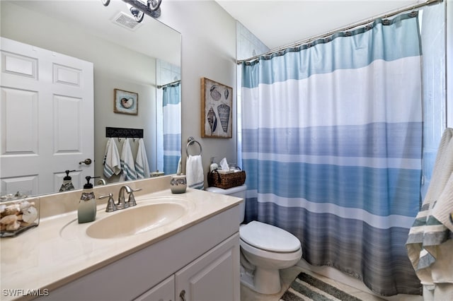 bathroom featuring toilet, vanity, and walk in shower