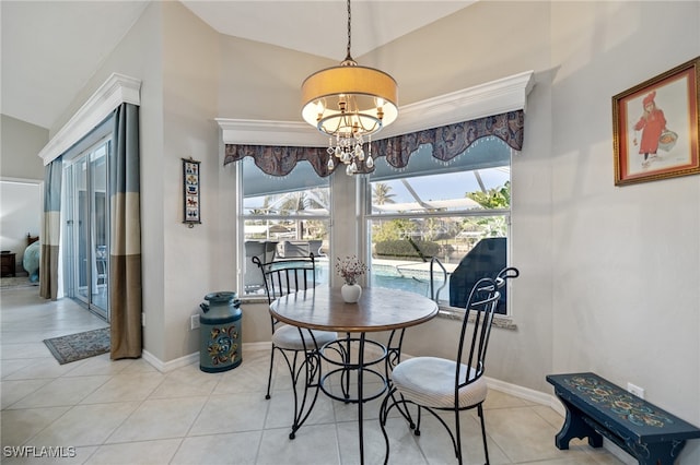 dining room featuring vaulted ceiling, light tile patterned flooring, and a notable chandelier