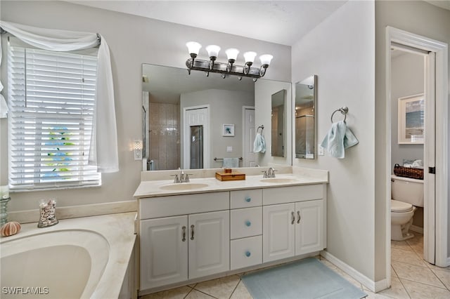 bathroom featuring vanity, tile patterned flooring, toilet, and tiled shower