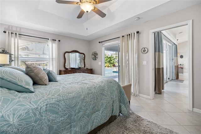 tiled bedroom featuring access to outside, ceiling fan, and a tray ceiling