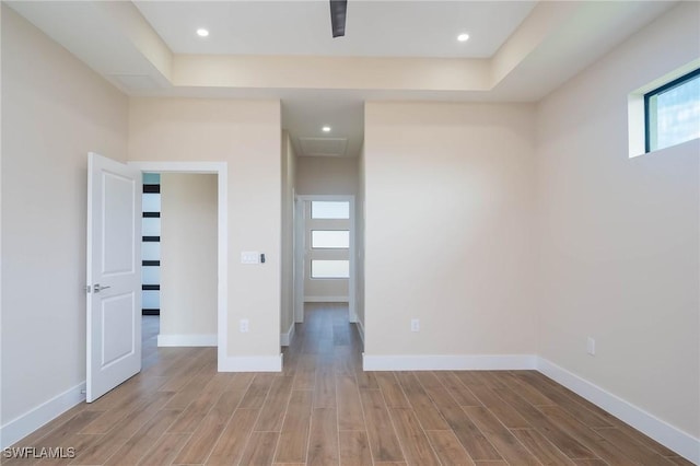 unfurnished room with a tray ceiling and a wealth of natural light