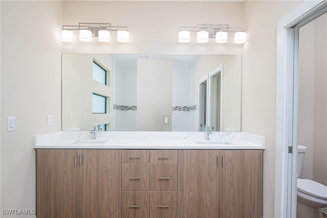 bathroom featuring vanity and toilet