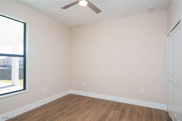 empty room featuring wood-type flooring and ceiling fan