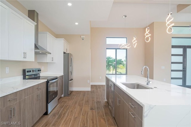 kitchen with hanging light fixtures, white cabinetry, sink, and stainless steel appliances