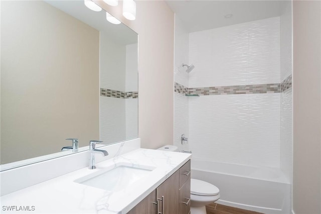 full bathroom featuring vanity, toilet, and tiled shower / bath