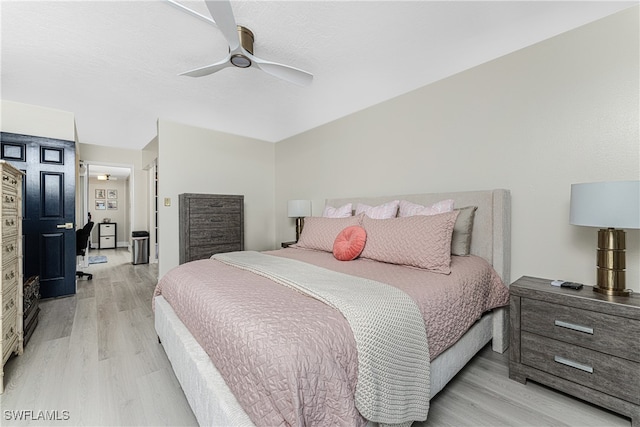 bedroom with ceiling fan and light hardwood / wood-style floors