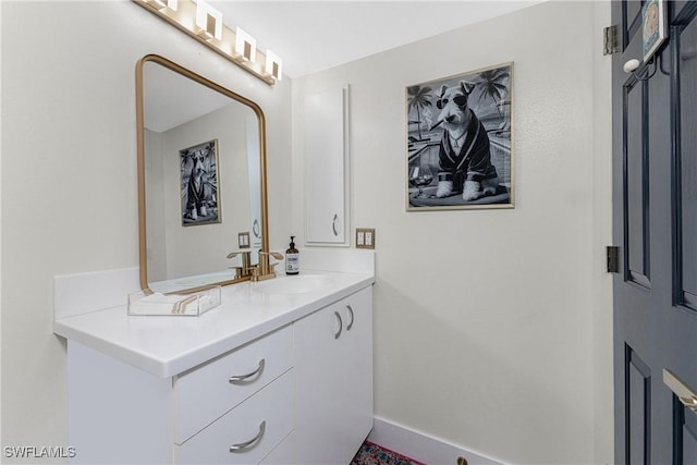 bathroom with vanity and baseboards