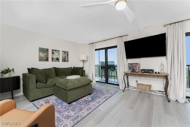 living room featuring light wood-type flooring and ceiling fan