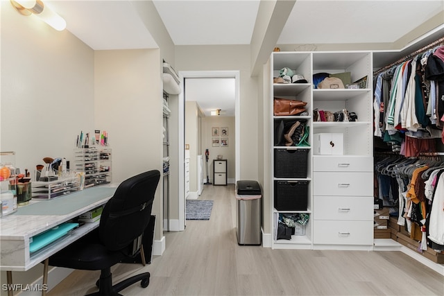 office area featuring light wood finished floors and baseboards