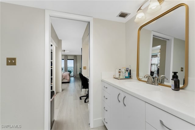 hallway with light hardwood / wood-style floors and sink