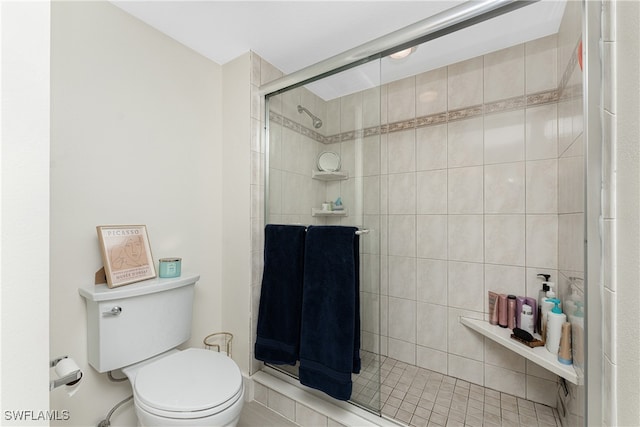 bathroom with toilet and a shower with door