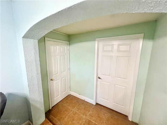 hallway with light tile patterned floors