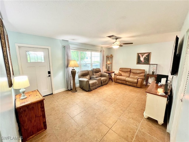 tiled living room with ceiling fan