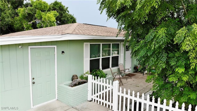 view of exterior entry featuring a patio