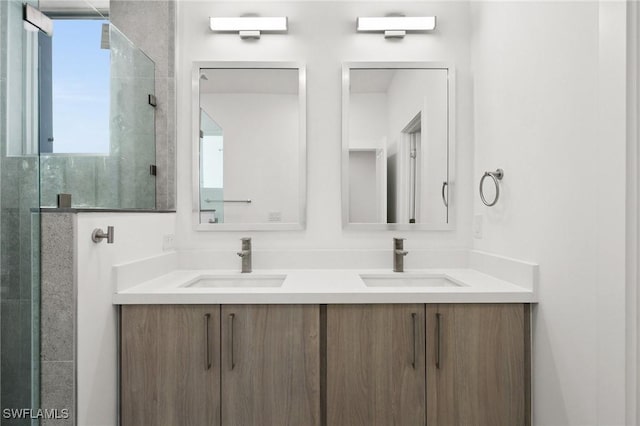 bathroom with vanity and a shower with shower door