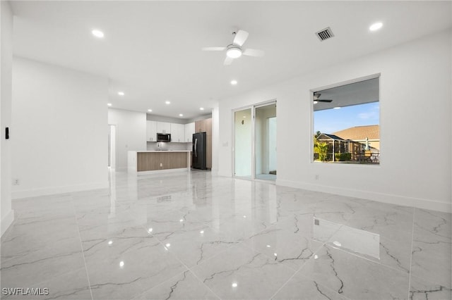 unfurnished living room with ceiling fan