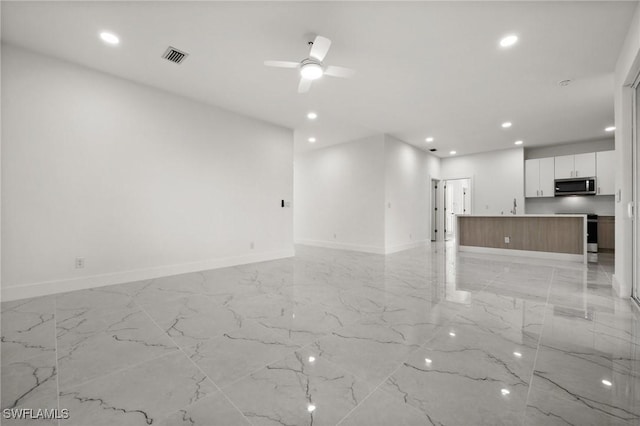 unfurnished living room featuring ceiling fan