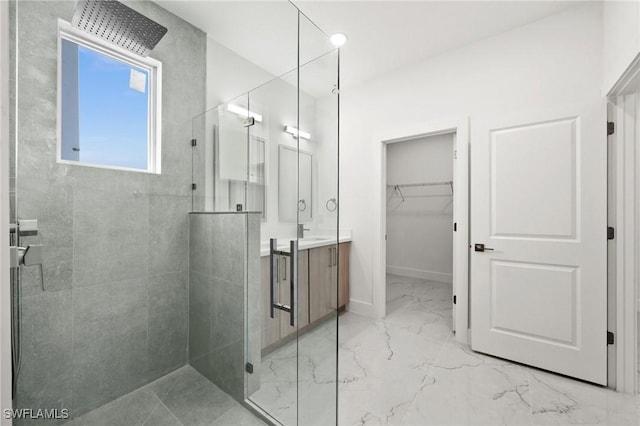 bathroom with vanity and a shower with shower door