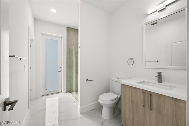 bathroom featuring vanity, toilet, and a shower with shower door