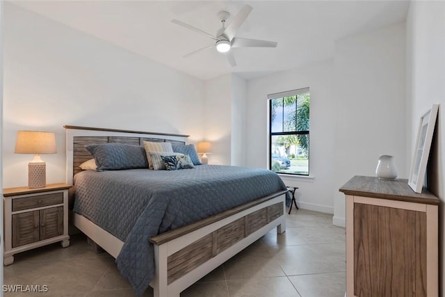 tiled bedroom featuring ceiling fan