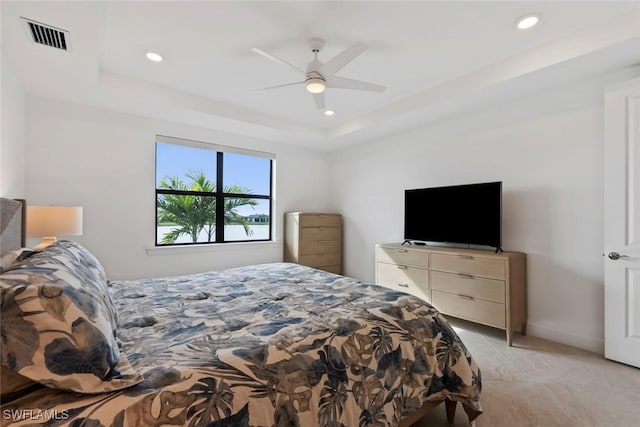 bedroom featuring a raised ceiling and ceiling fan