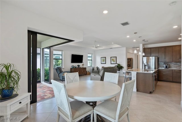 dining room with ceiling fan and light tile patterned floors