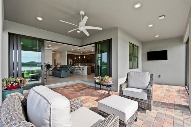 view of patio featuring ceiling fan and an outdoor living space